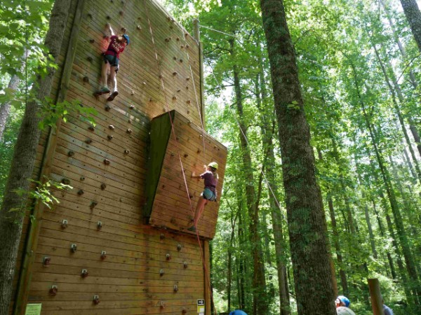 ACC 4-H Junior camp participants scaling a rock wall